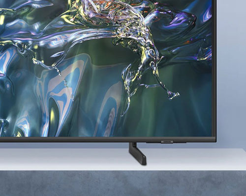 A QLED TV is placed on an Adjustable Stand.