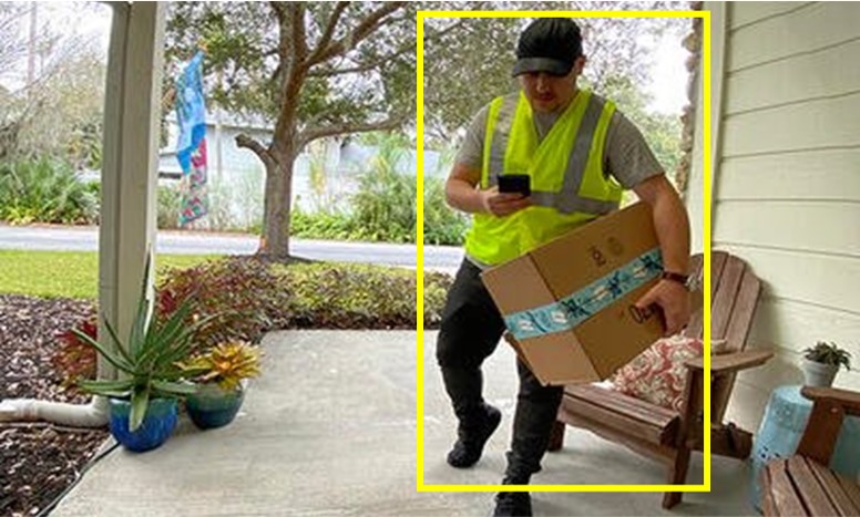 Delivery person dropping off box at residence