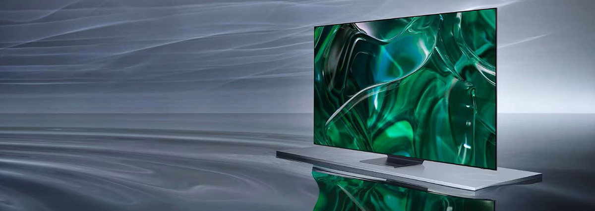 An OLED TV is displaying a green graphic on its screen while floating on top of a gray surface.