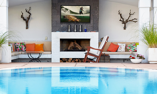 Outdoor pool with TV installed in covered porch