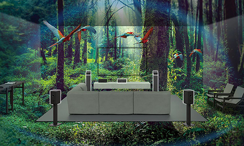 Image of a sofa, TV and speakers in the middle of a forest with parrots flying around
