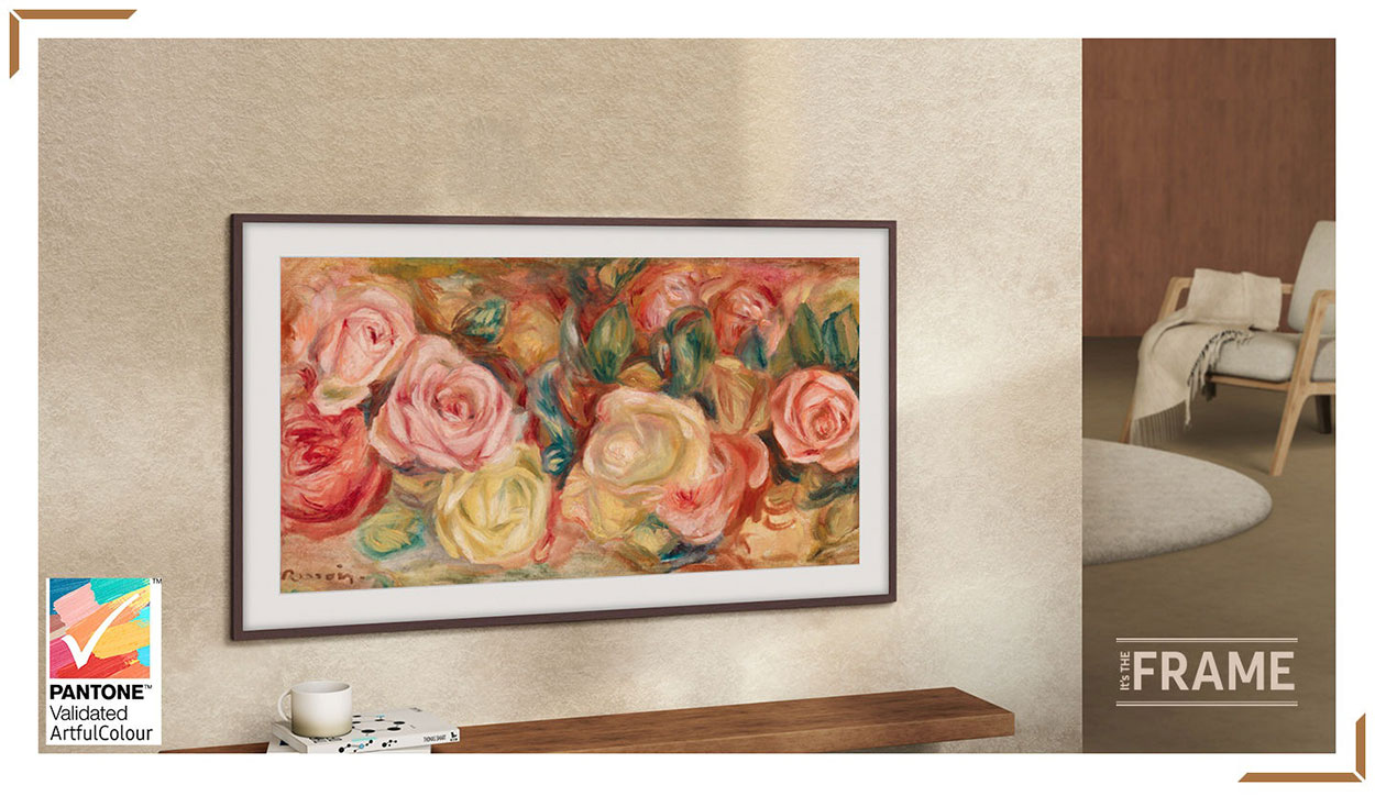 The Frame TV is set on a wall. The screen shows a painting of roses. A logo reads It's The Frame.